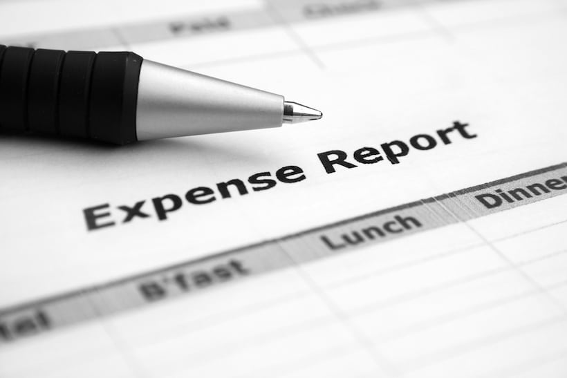 Close up of an expense report and ballpoint pen