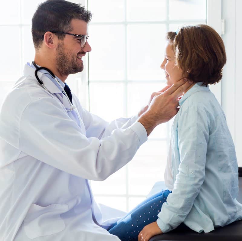 Girl being examined by pediatrician in the office.