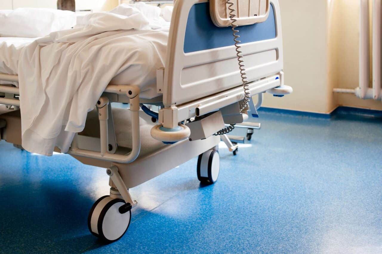 Empty hospital bed on hospital ward