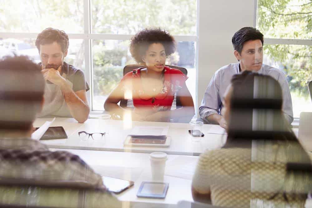 Designers Having Meeting Viewed Through Window